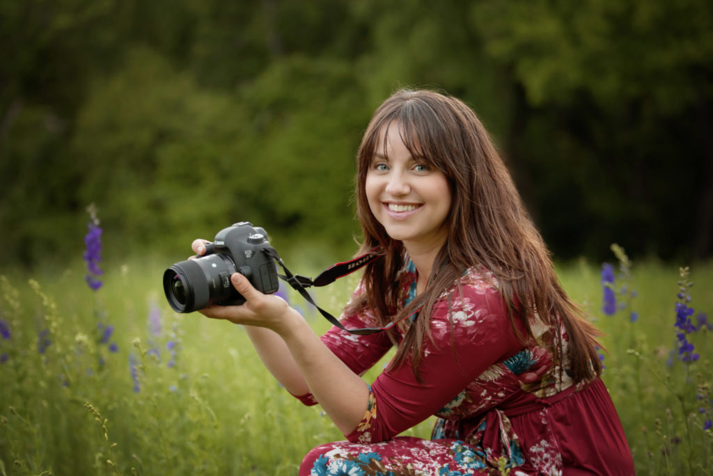 Dallas newborn and maternity photographer Laura Levitan of Mod L Photography posing in wildflower field