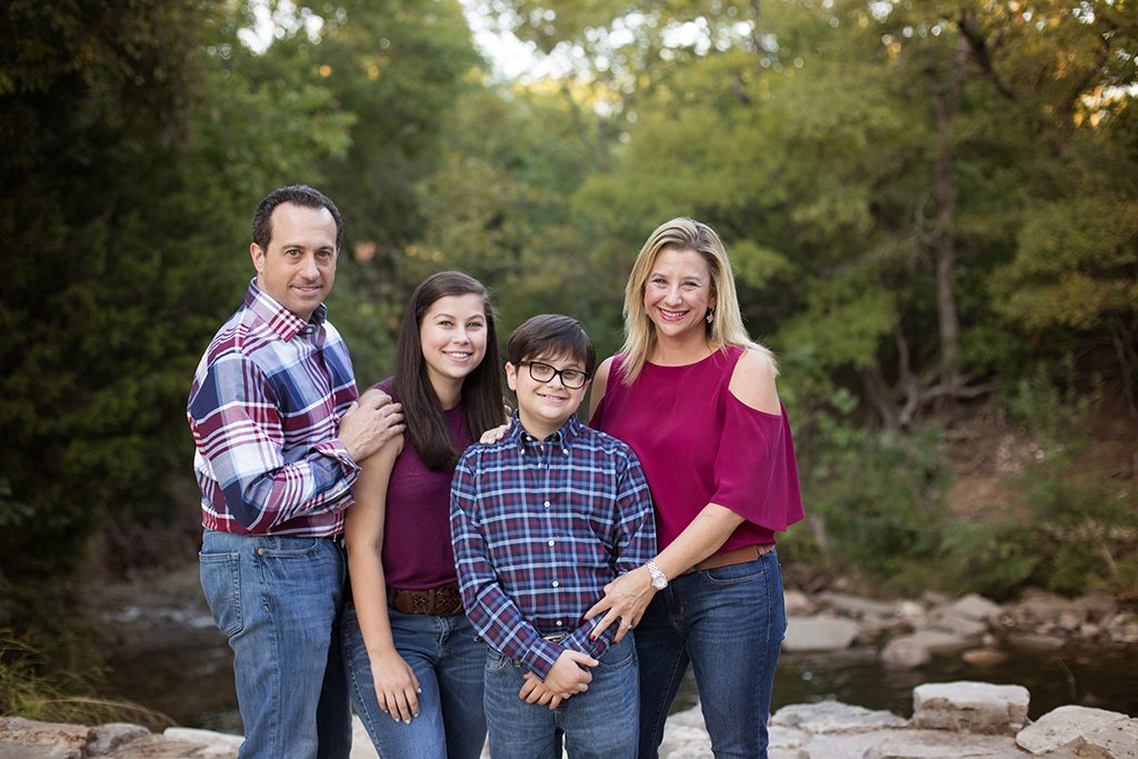 Dallas Family posing at sunset at Prairie Creek Park by a waterfall