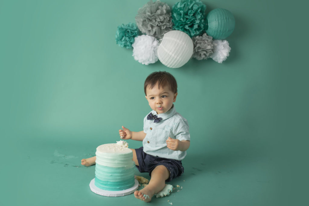 cake smash photographer in dallas creates beautiful teal ombre cake smash theme