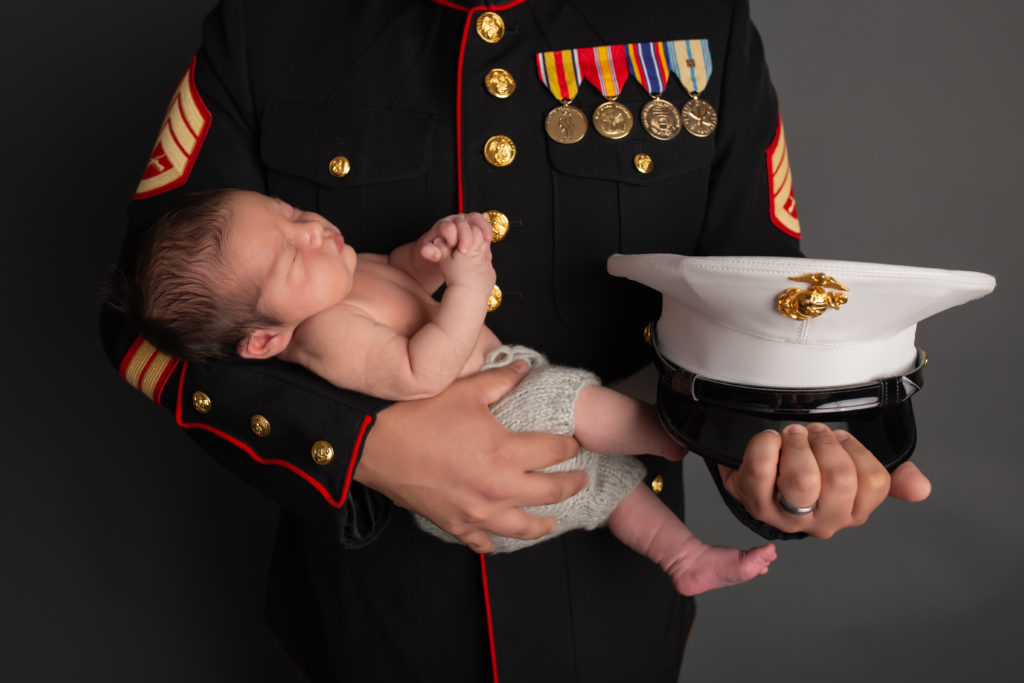Dallas newborn photographer honors veteran dad in this photo of baby held by marine father