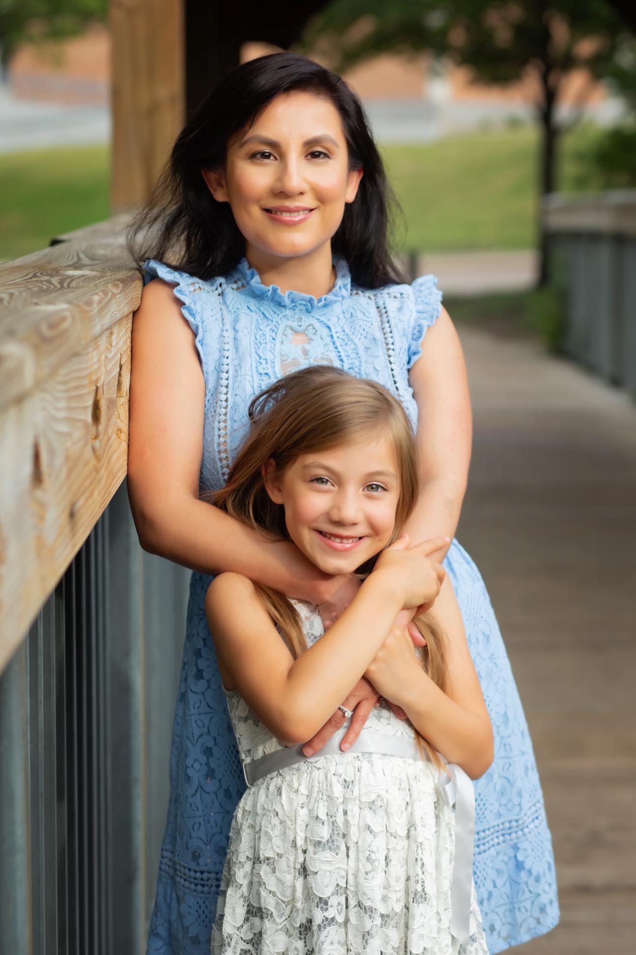 Dallas family photographer shares portrait of mom and daughter on bridge in Prairie Creek Park in Richardson Texas