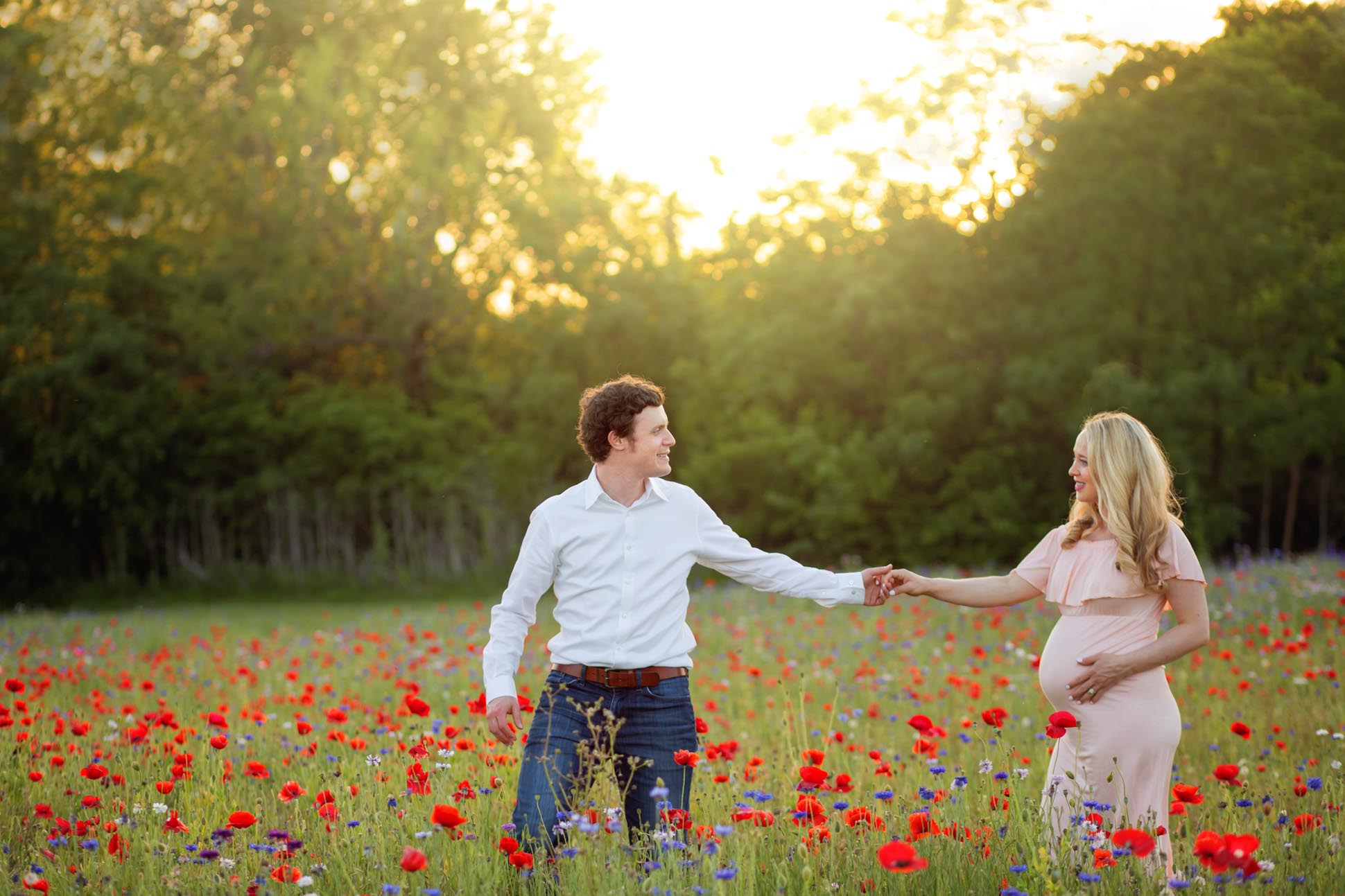 Dallas maternity photographer shares portrait of pregnant mom and husband in a field of flowers in Richardson Texas