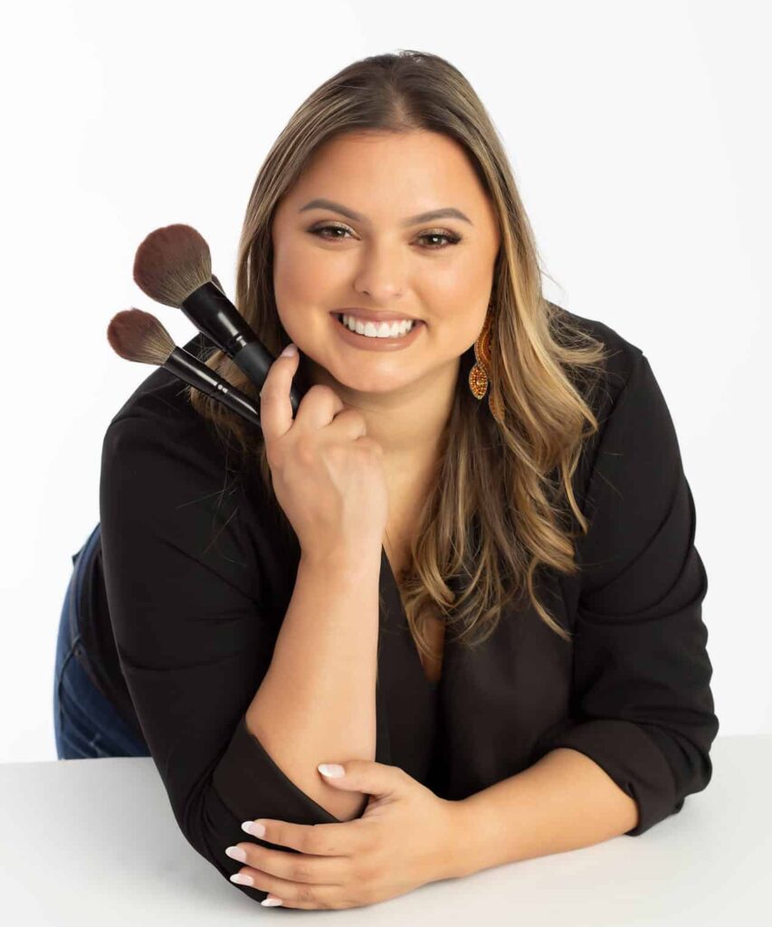 Local hair and makeup artist pictured in headshots and branding photoshoot with her makeup brushes
