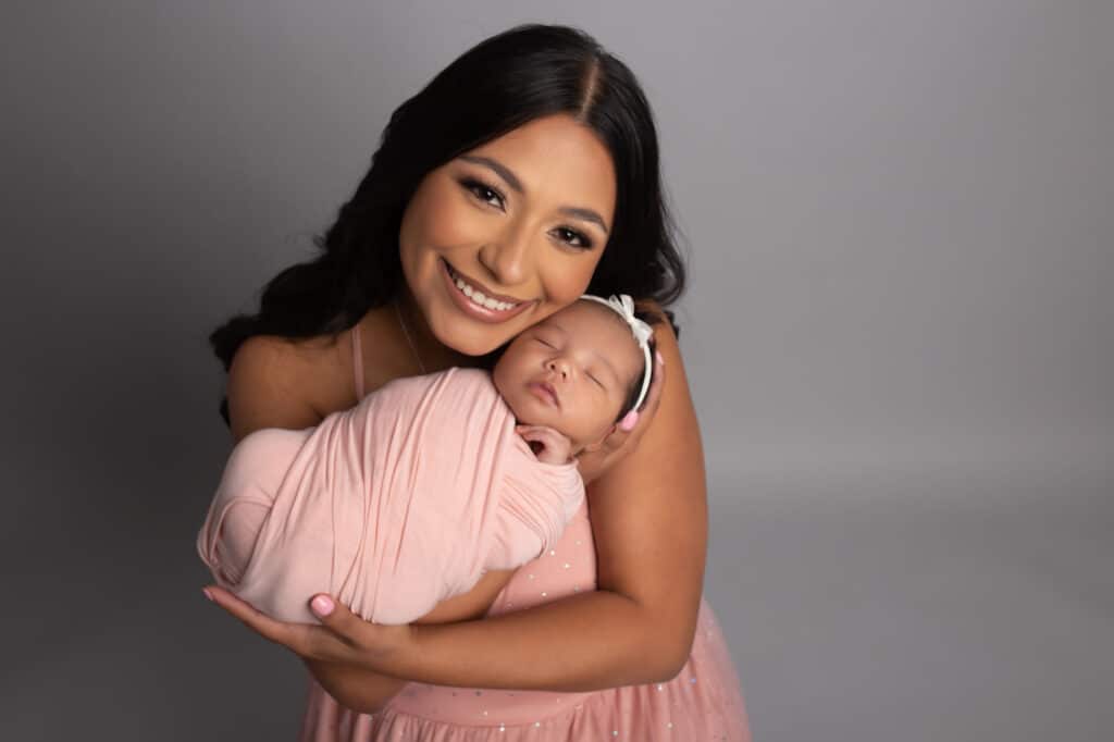 Mom and baby pose for newborn photography session both dressed in pink for Dallas newborn photographer Mod L Photography based in Addison, Texas